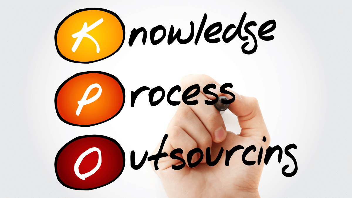 knowledge process outsourcing A hand holding a pen pointing to the words, knowledge process outsourcing