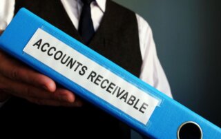 A man holding a folder labeled accounts receivable