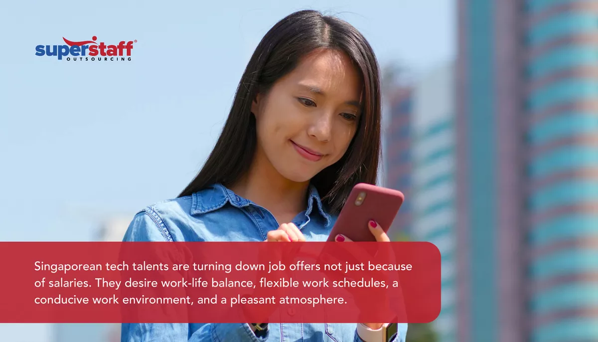 Singaporean-Tech An image shows a woman looking at her phone and captions explaining why there's widespread Singapore labor shortage.
