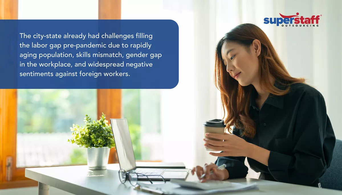 The-City-State An executive looks at her laptop, analyzing the Singapore labor shortage.