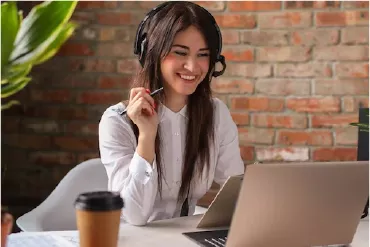 Girl Facing a Laptop and Smiling