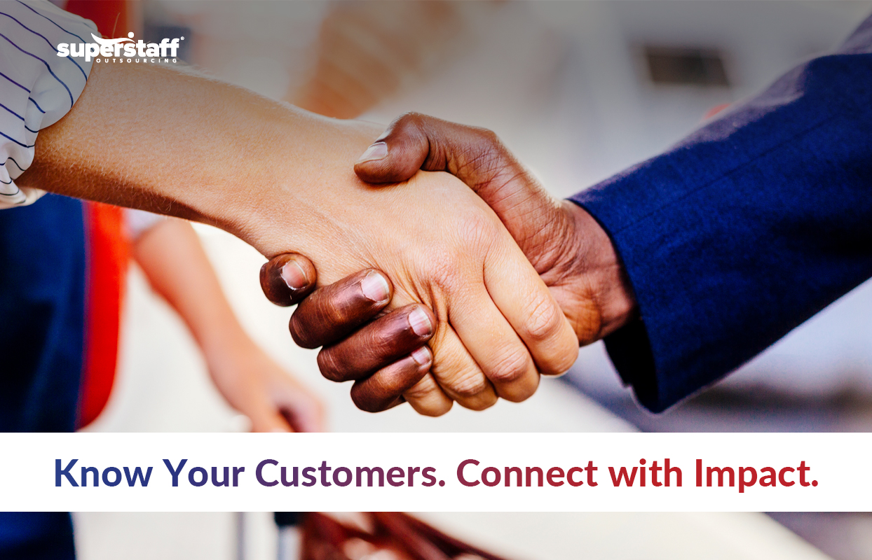 More-Than-Just-a-Call_Featured The image shows a close-up of two people shaking hands, symbolizing trust and connection. One person has a darker skin tone and is wearing a dark blue suit, while the other has a lighter skin tone and is wearing a white long-sleeved shirt. The background is blurred, with hints of people and movement, suggesting a professional or business setting. The **SuperStaff Outsourcing** logo is placed in the top left corner. Below the handshake, a bold message reads: "Know Your Customers. Connect with Impact." The image conveys the importance of understanding and building relationships with the right buyer persona to create meaningful business connections.