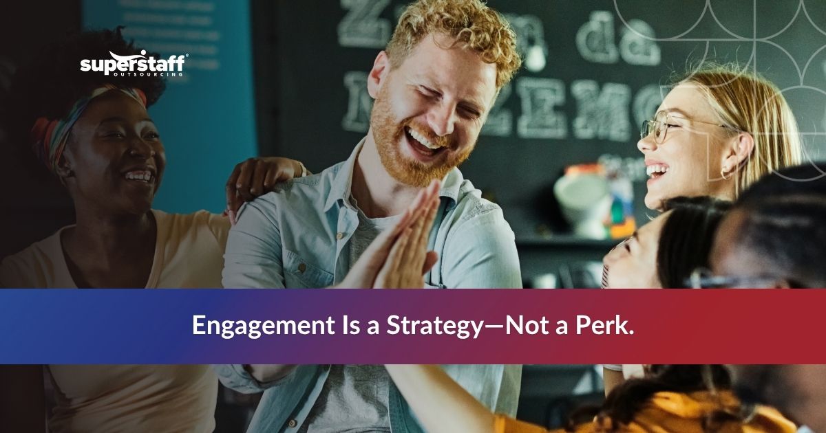 Smiling office workers sharing a light moment, contrasting with common causes of employee disengagement in the workplace