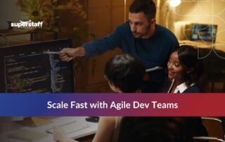 Team brainstorming on software development outsourcing benefits for startups, showcasing collaboration and coding.