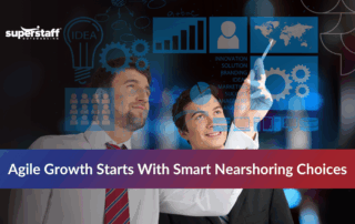 Two professionals discussing nearshoring meaning while viewing a map on a computer screen.