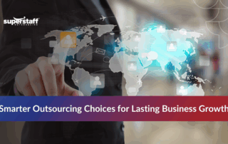 Hand pointing at the US on a world map, representing US companies that outsource for global growth.