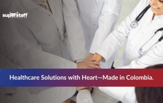 Healthcare workers putting hands together to represent teamwork in outsourced healthcare services.