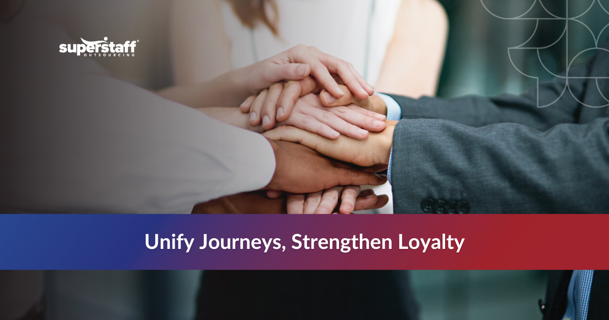 Team hands stacked together, symbolizing unity and outsourcing in customer communications management.